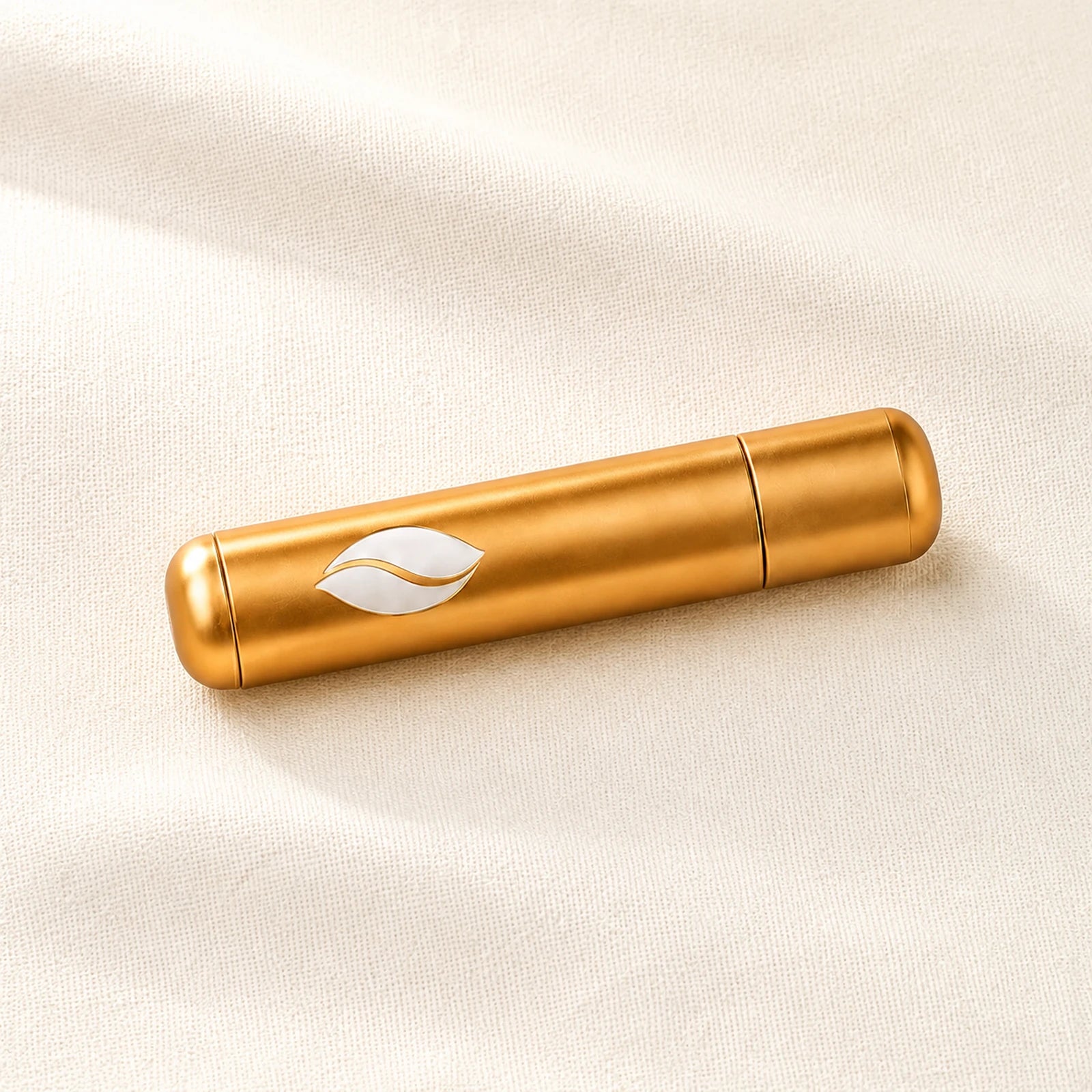 The reusable gold Presence Anchor aroma inhaler.
